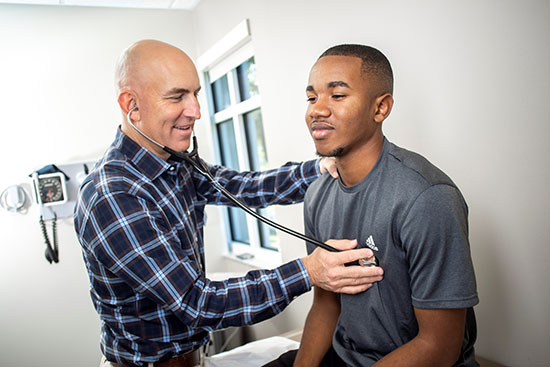 Doctor examining a young guy